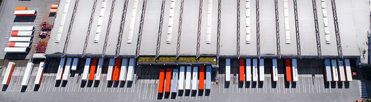 An overhead view of van trailers lining the loading docks a Schneider warehouse facility