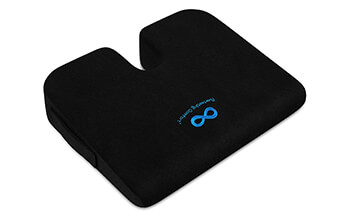 The black, wedge shaped Everlasting Comfort Car Seat Cushion is displayed in front of a white background.