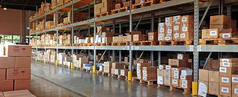 Pallets of boxes line the racks in a Schneider warehouse facility