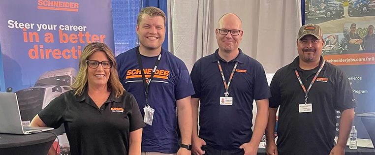 Schneider field recruiters in their booth at a hiring event.