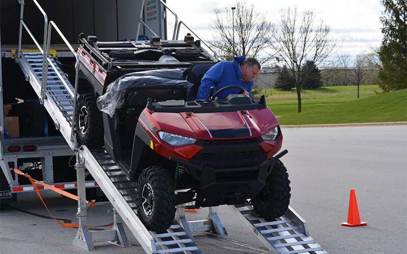 Schneider Dedicated driver delivering UTV off trailer