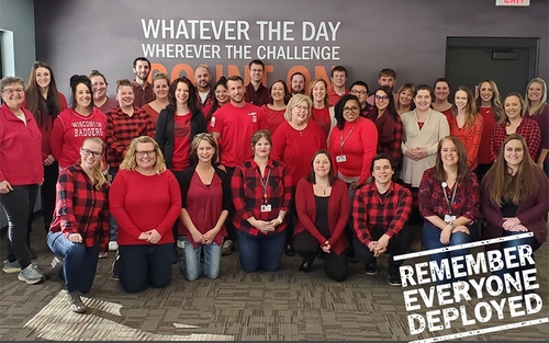 Schneider associates wearing red on Friday to remember everyone deployed