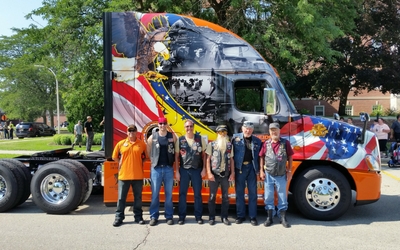 U.S. veterans pose with 2016 Ride of Pride truck