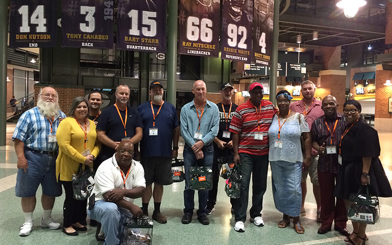 Schneider Advantage Club drivers pose for a photo at a sporting event