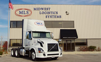 A white Midwest Logistics Systems day cab semi truck parked in from of the company's headquarters in Celina, Ohio.