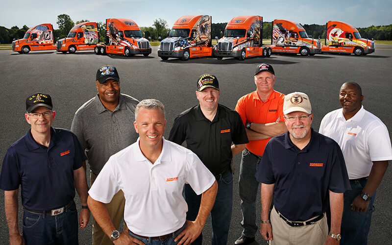 Schneider's Ride of Pride drivers with their Ride of Pride trucks.