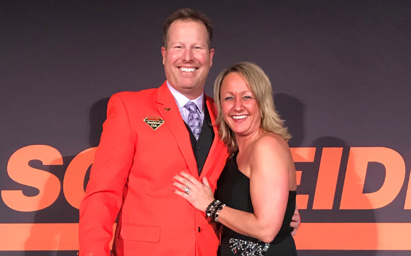 Ray Wilder poses for a picture with his wife, Sarah Wilder, at a Schneider company event