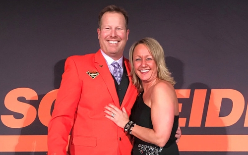 Ray Wilder poses for a picture with his wife, Sarah Wilder, at a Schneider company event