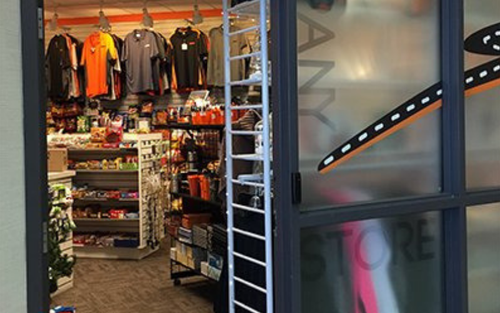 Schneider apparel and other merchandise lines the racks of the company store.