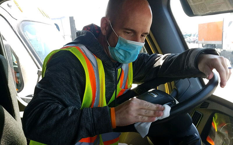 Truck driver wearing mask earning Performance Pay Plus