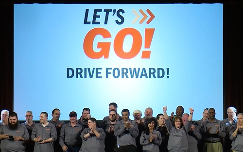Schneider truck drivers gather under text that reads "Let's go! Drive forward!"