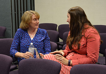 Schneider associates chat one-on-one at an event.