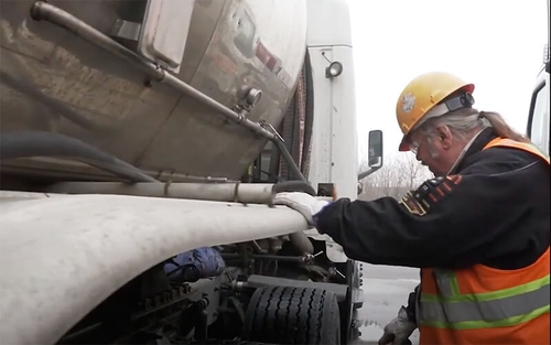 Schneider Tanker truck driver Wesley Buck looks over his bulk trailer while doing a pre-trip inspection.