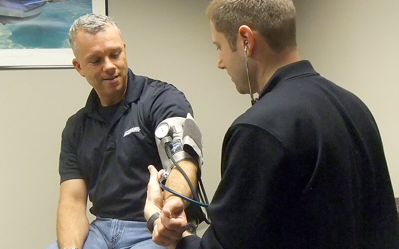 A Schneider driver has his blood pressure checked during a DOT physical.