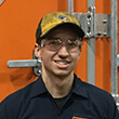 Headshot of Isaiah at a Schneider diesel shop