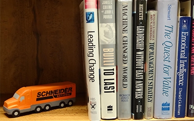 Business books line the shelves of Don Schneider's library