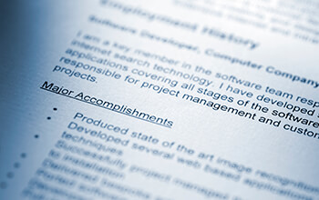 A zoomed-in shot of a resume focuses on someone's, "Major Accomplishments" section, which has many bullet points under it.