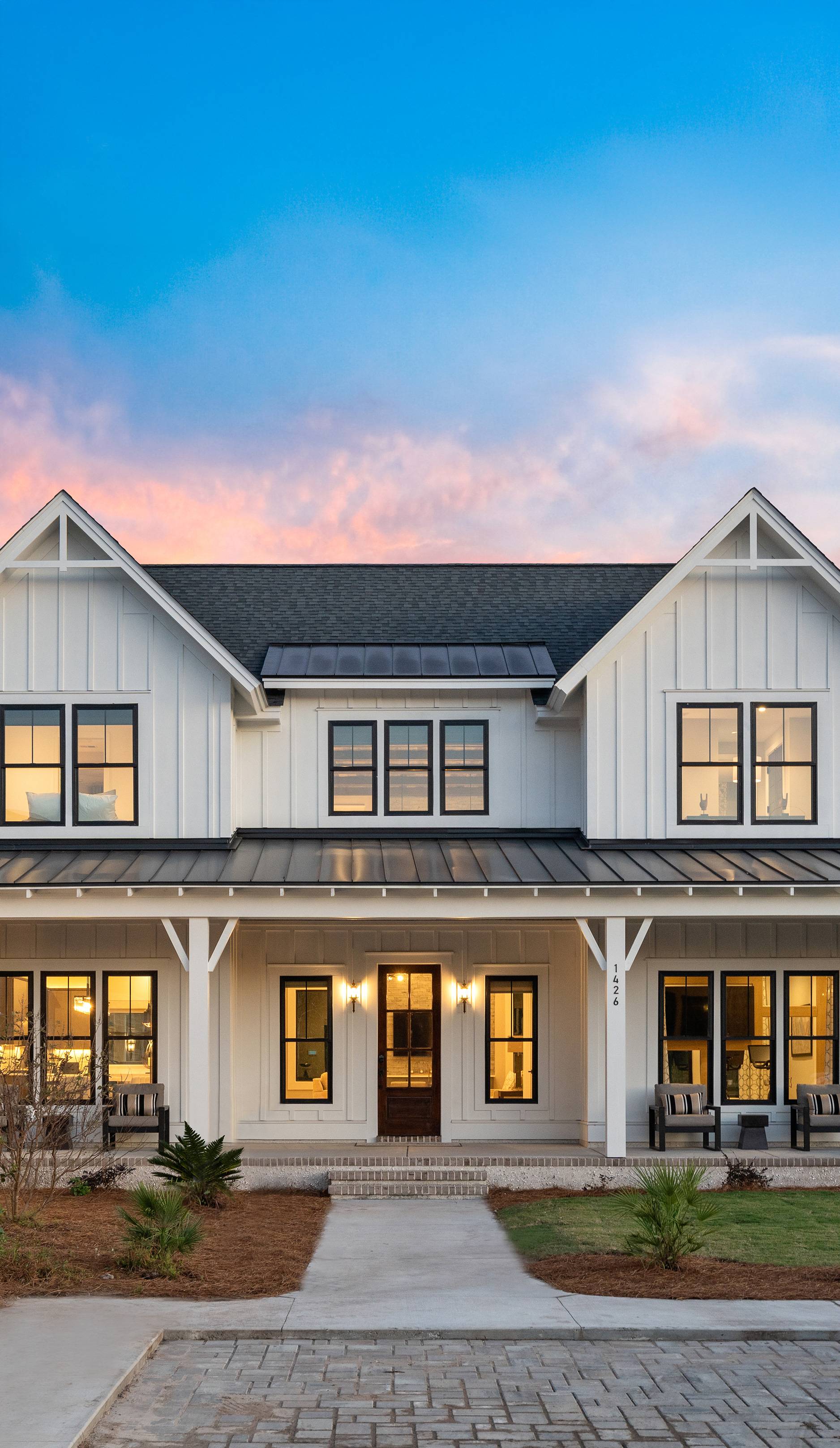 Close up of 3 windows on home with white siding.