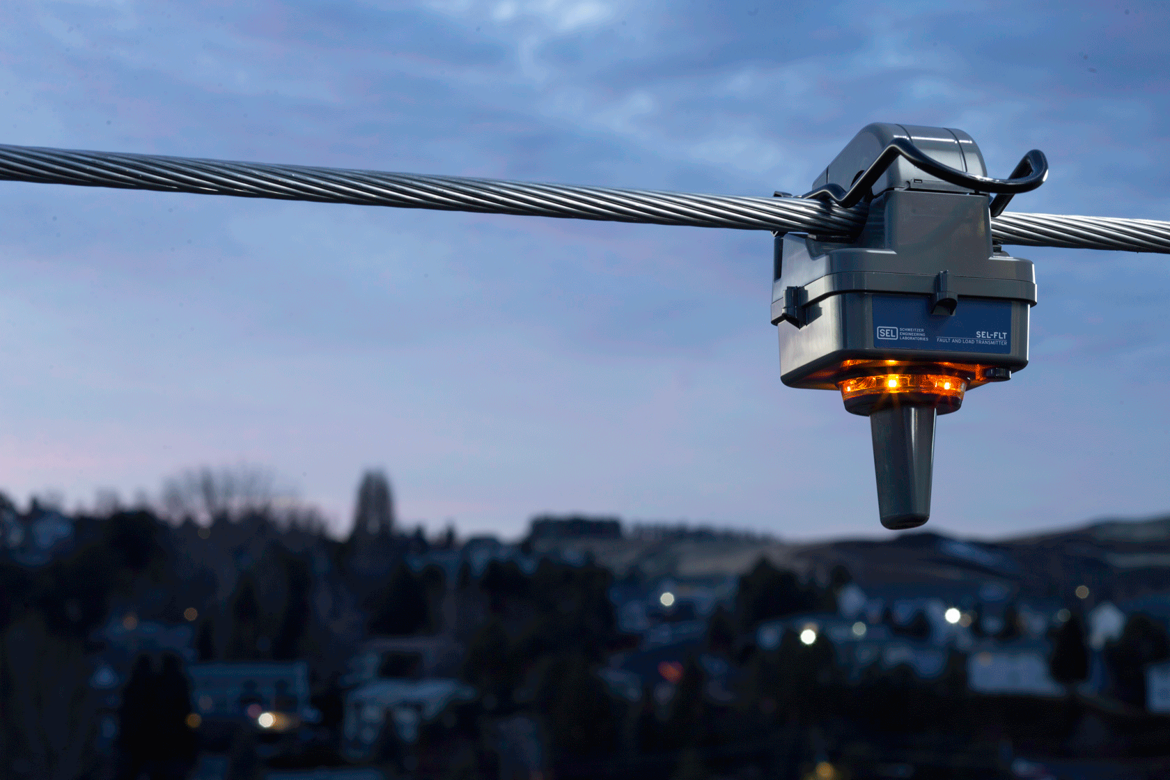 An above ground fault indicator on a power line flashing