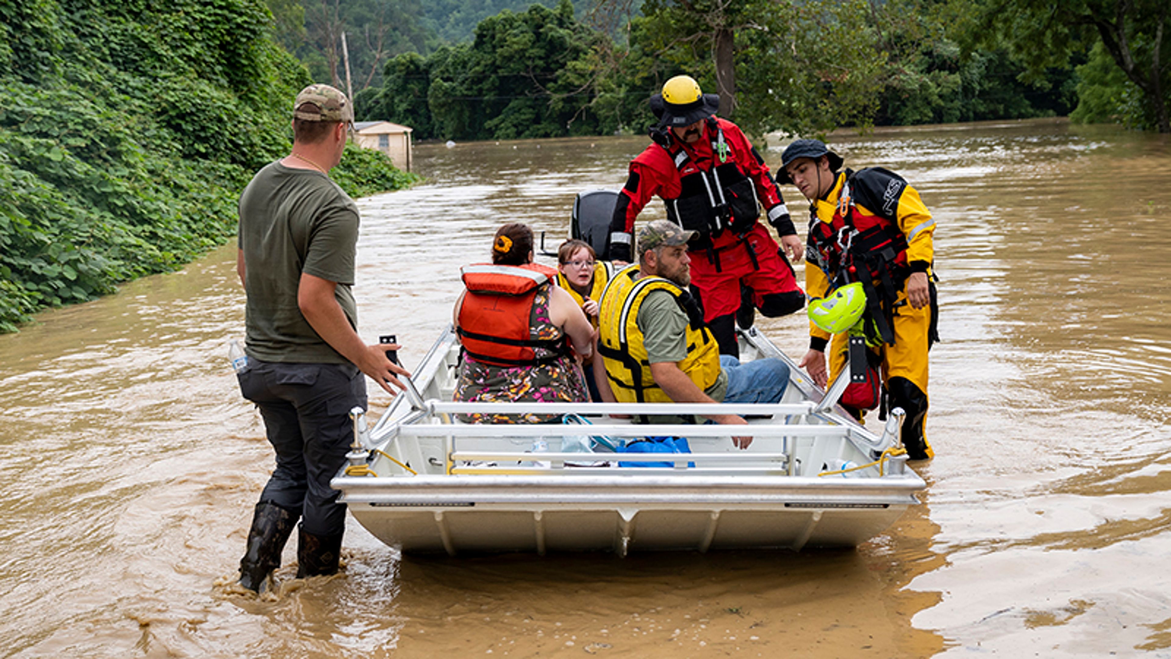 Rescue workers helping flood victims on a boat