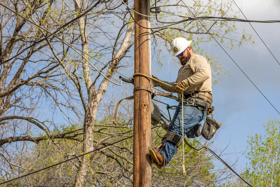 Electric lineman working on a pole