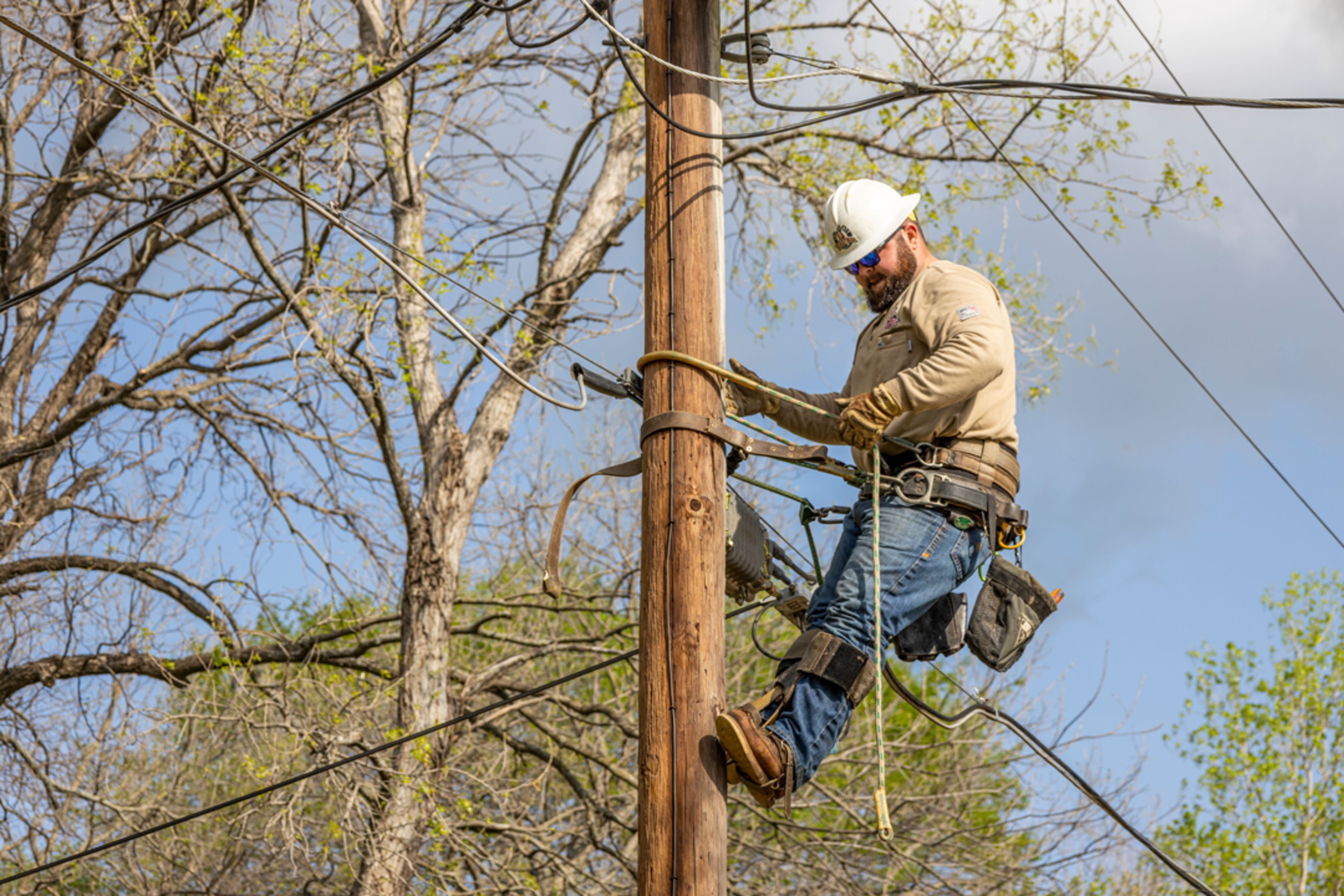 Electric lineman working on a pole