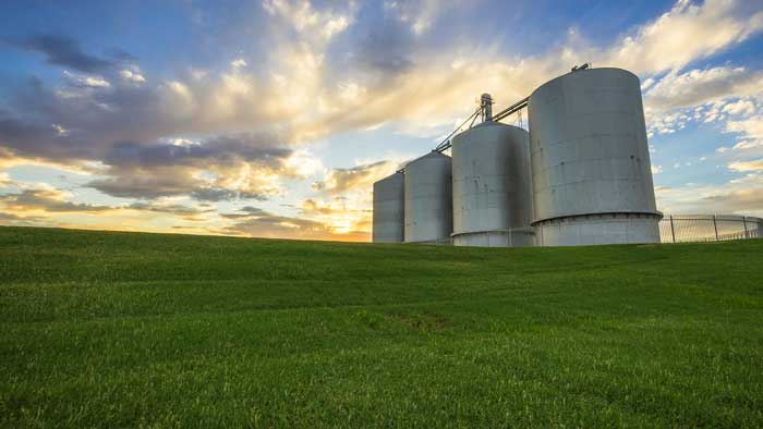 Grain bins and moody, cloudy sky