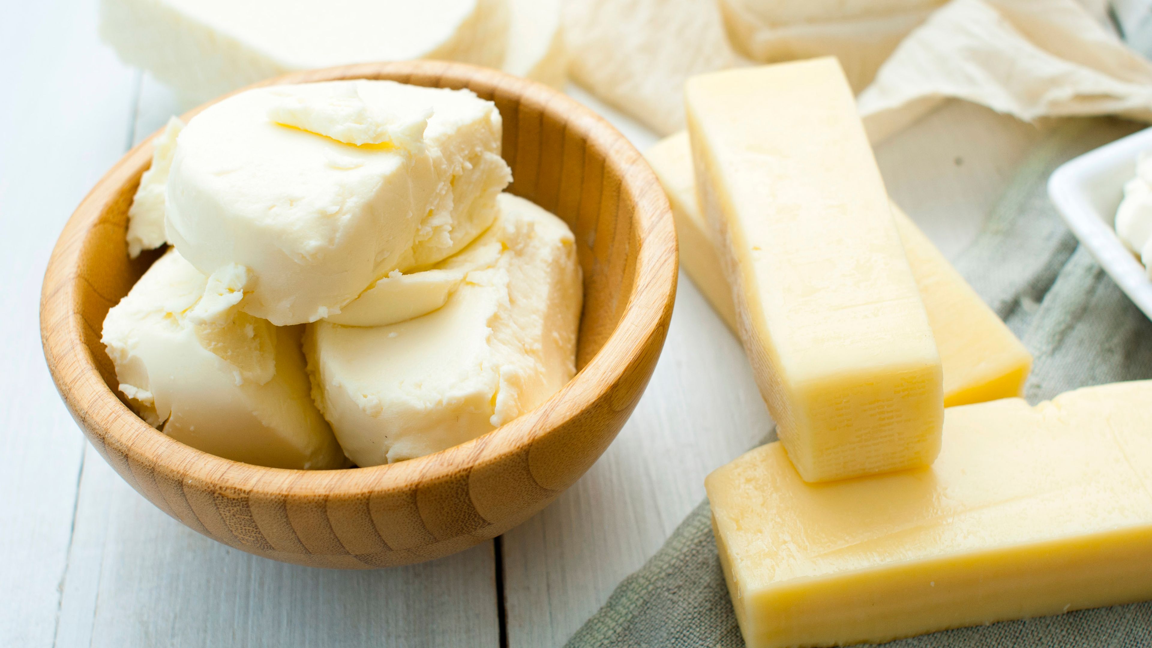 butter and cheeses displayed on a table