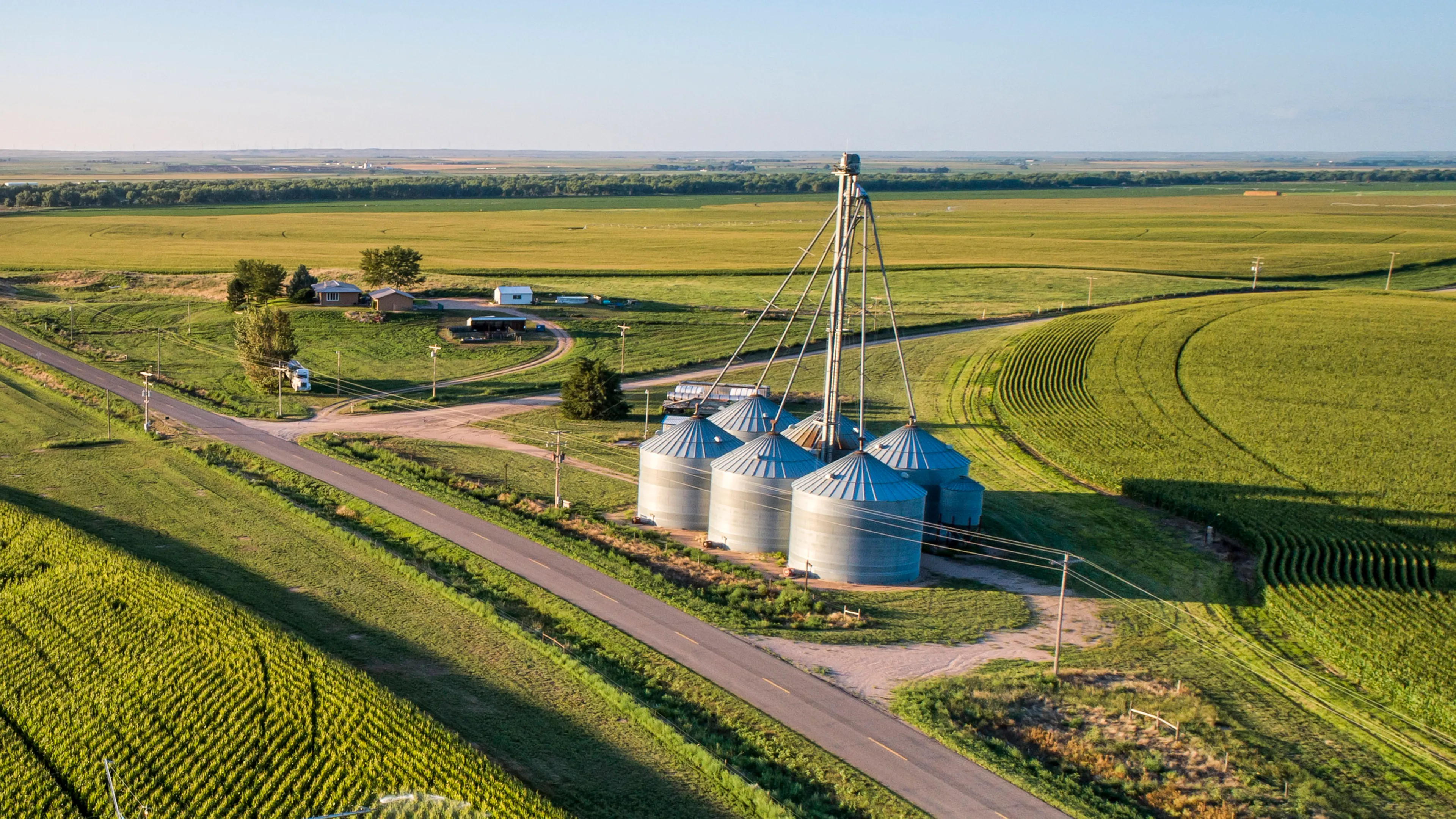 Farmstead with grain bins and fields viewed from an aerial perspective