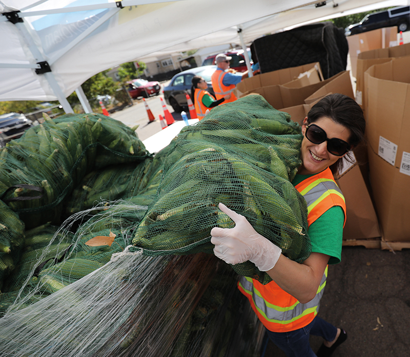 Woman unloading sack of donated food
