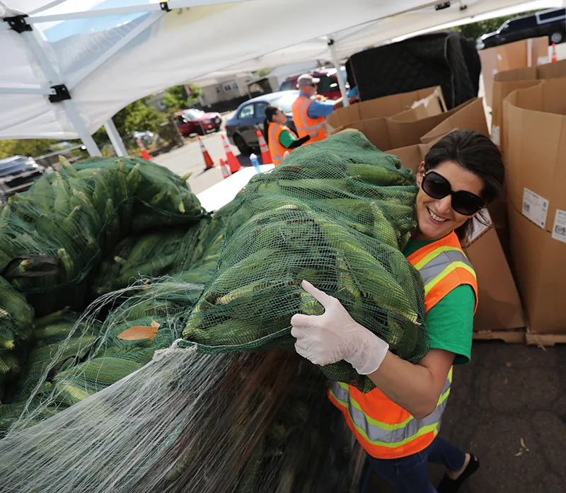 Woman unloading sack of donated food