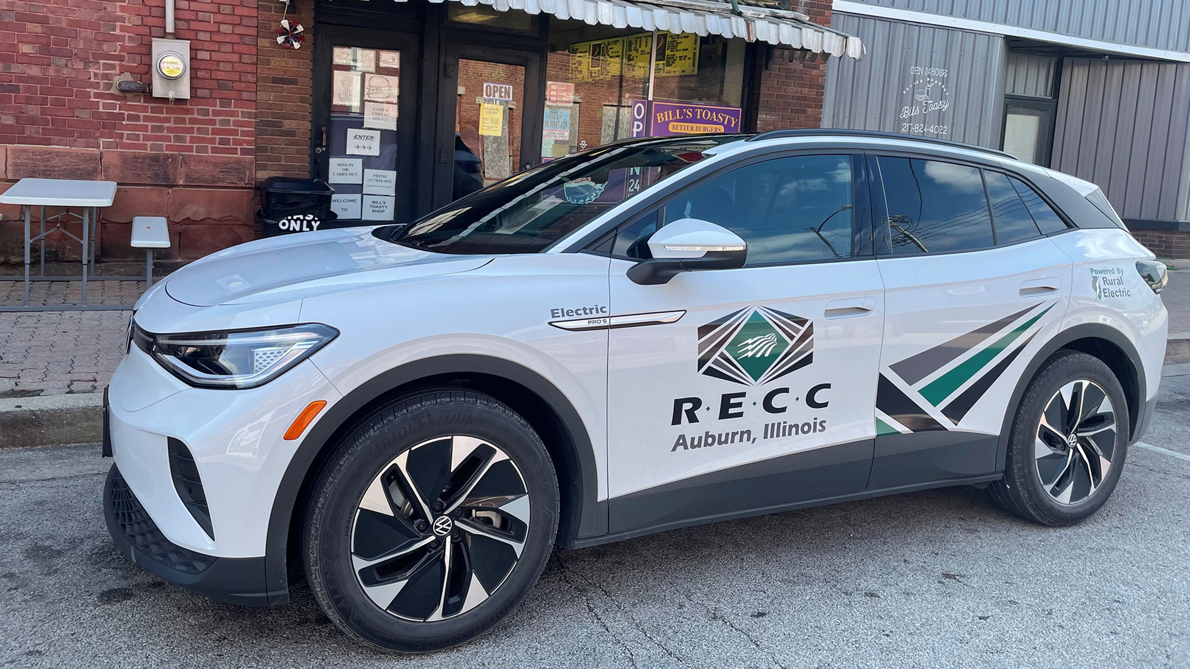 Electric SUV with company branding parked in an urban setting