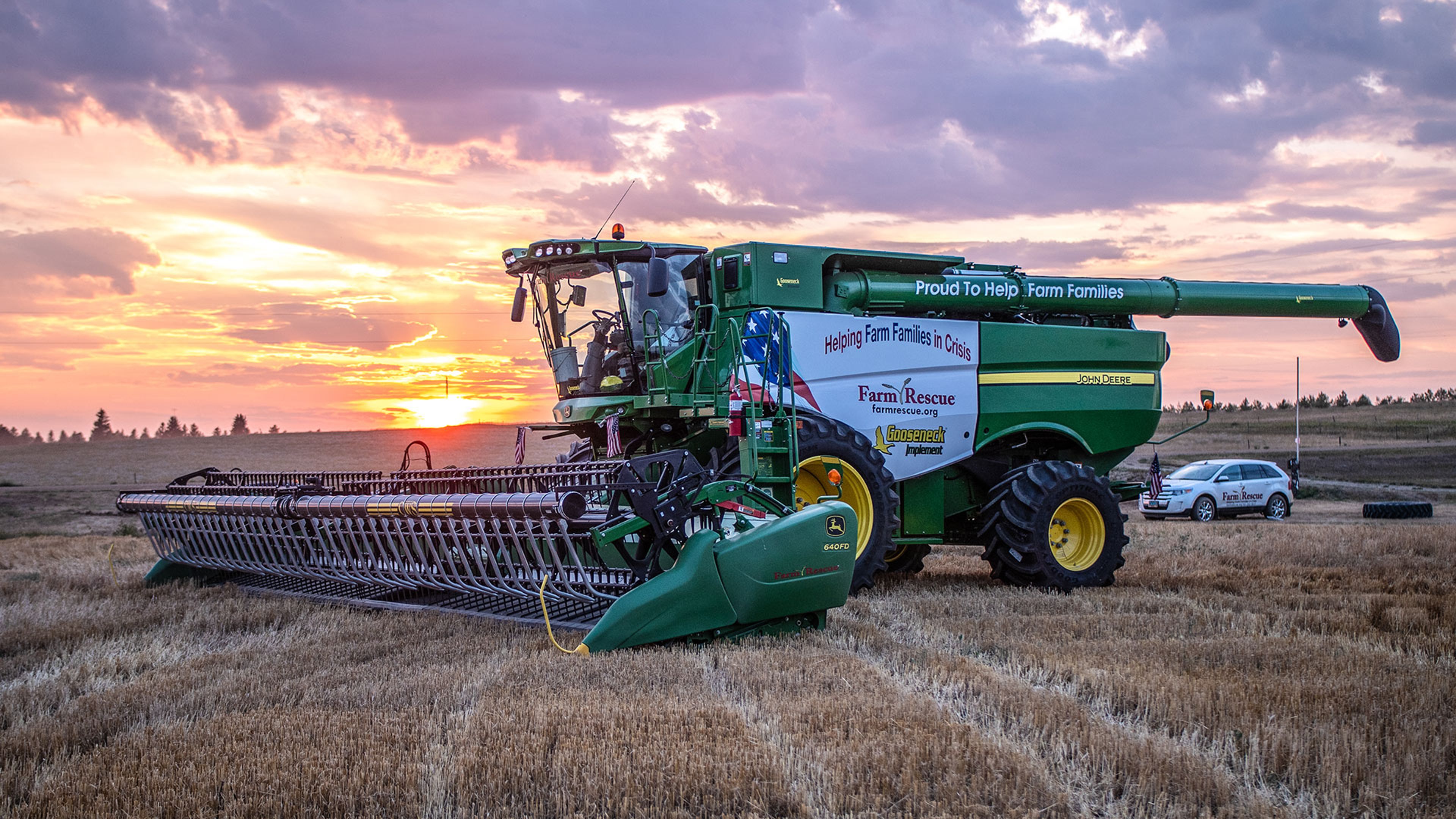 Green combine harvester in a wheat field