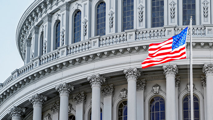 Capitol building with the United States flag in the foreground