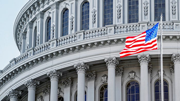 Capitol building with the United States flag in the foreground