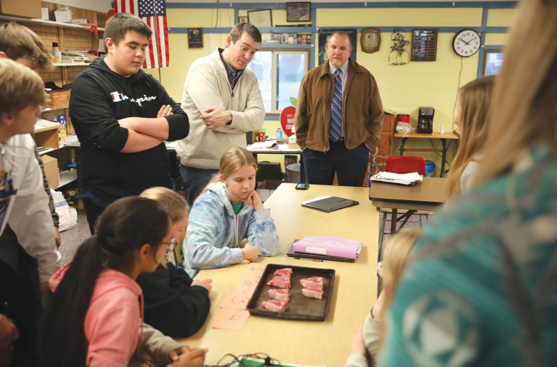 Joe Sherwood, superintendent of Morrill Public Schools, joins teacher Shane Buchholz and the students of Morrill’s “Intro to Agriculture” class.