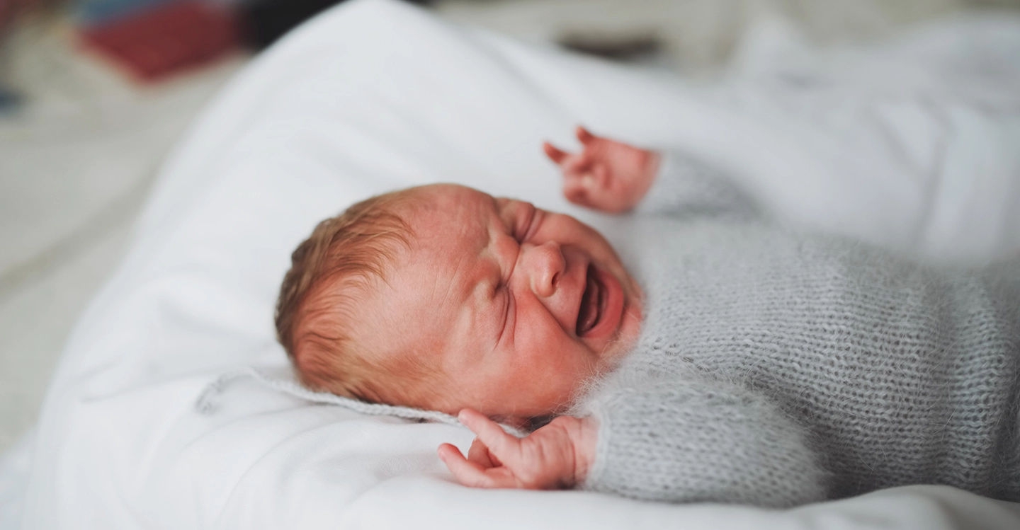 Why do newborn babies cry so much?