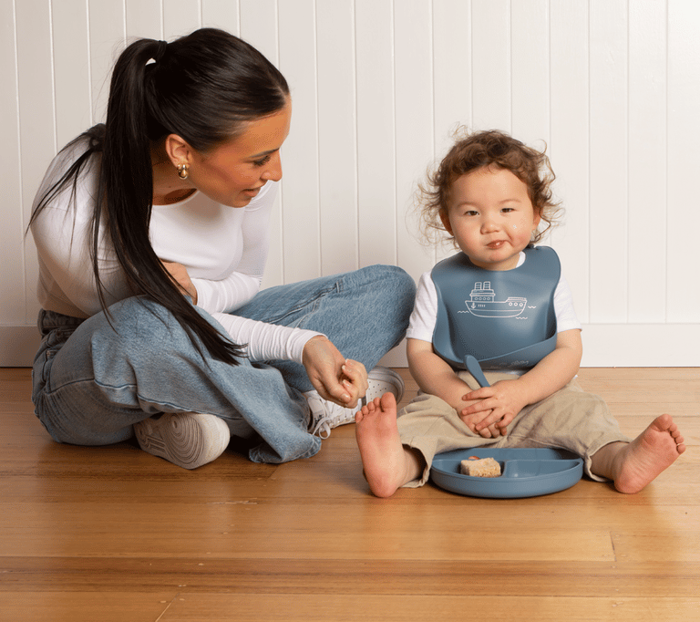 All4Ella Banner with child wearing a long sleeve bib