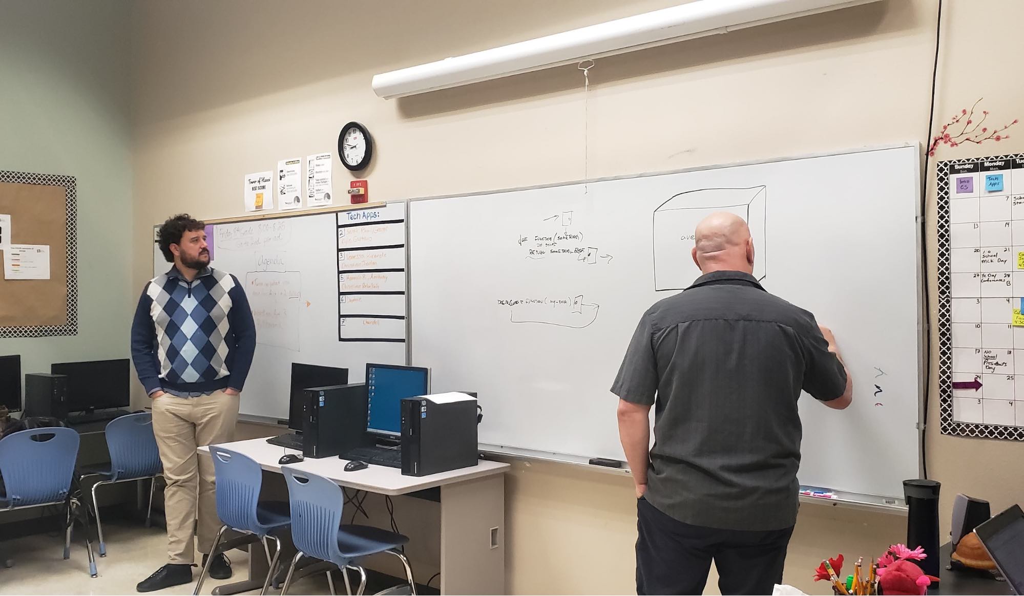 TEALS volunteer teachers at whiteboard