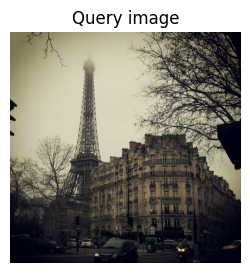 Grayscale photo of the Eiffel Tower surrounded by Haussmann-style buildings on a foggy day, used as the query image for image-to-image similarity search.