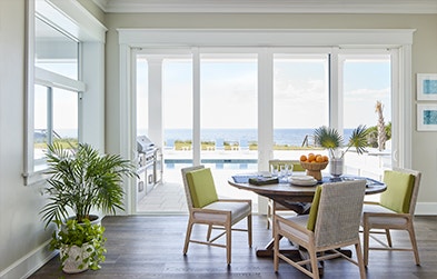 viewing the ocean from inside the kitchen through a white vinyl patio door