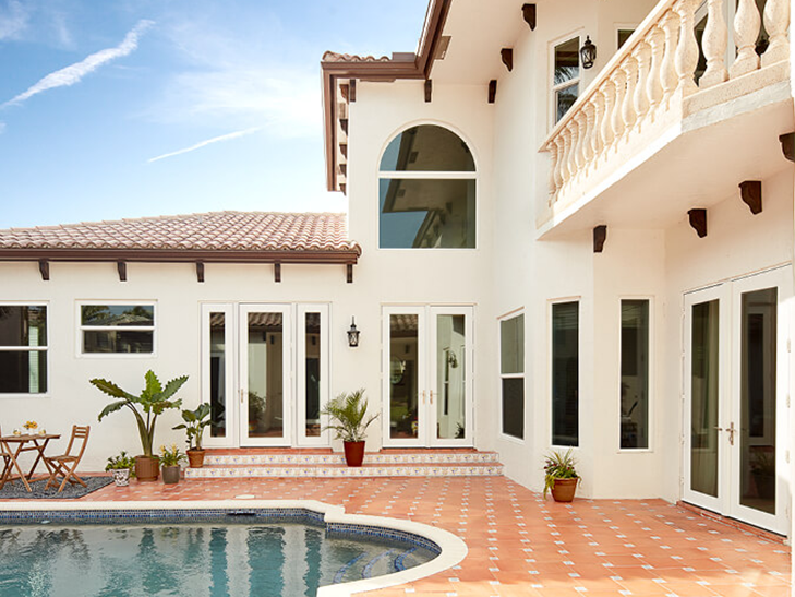 a spanish-style courtyard with a pool