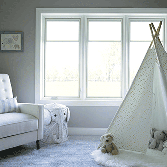 a child's nursery with white casement windows