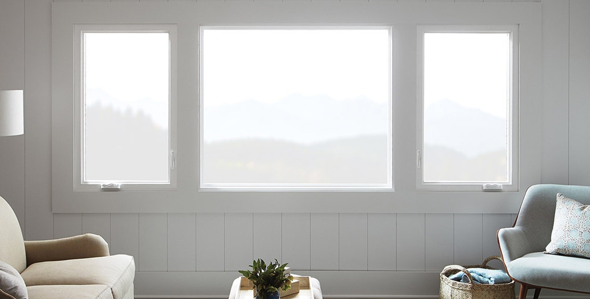 two white casement windows flanking a large white picture window