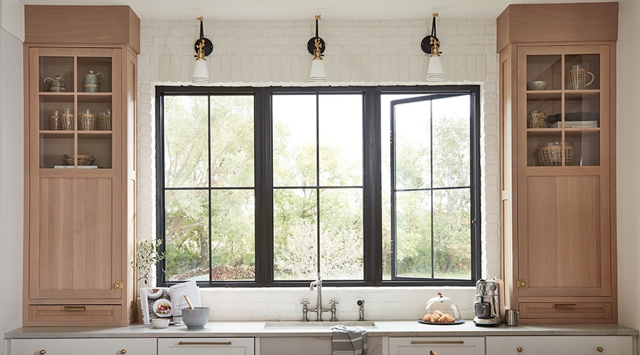 two white casement windows flanking a large white picture window
