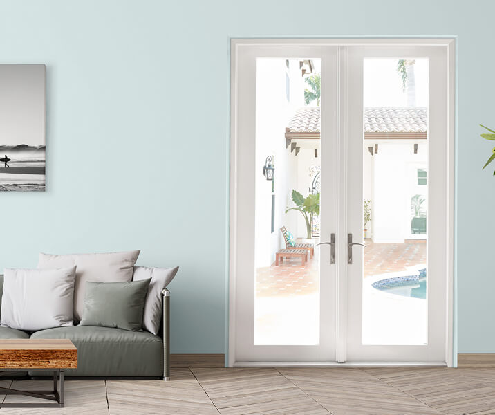 a white hinged door on a teal home