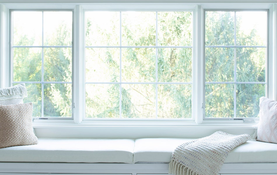 three white lifestyle series windows over a white windowseat