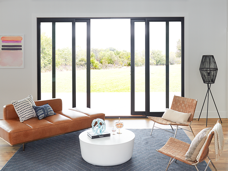 a contemporary living room with minimalist furniture and french sliding patio doors