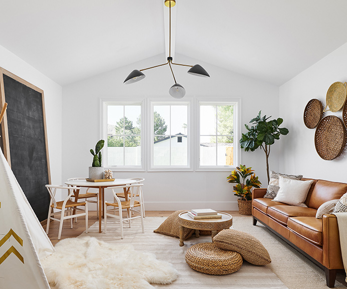 two tall casement windows reflect the sunset