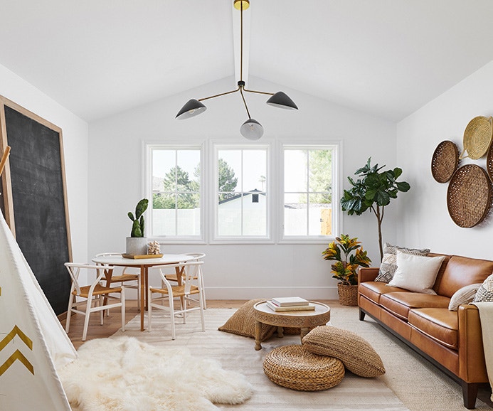 two tall casement windows reflect the sunset